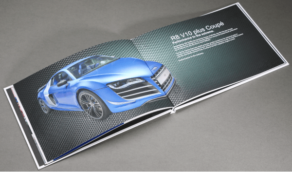 Premium bound book illustrating a blue R8 V10 Coupe car