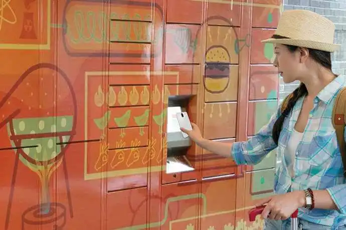 a woman using a parcel locker