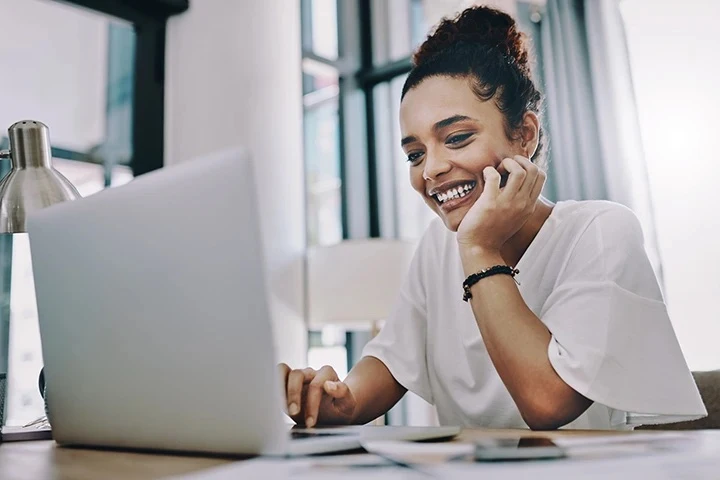 woman smiling at laptop